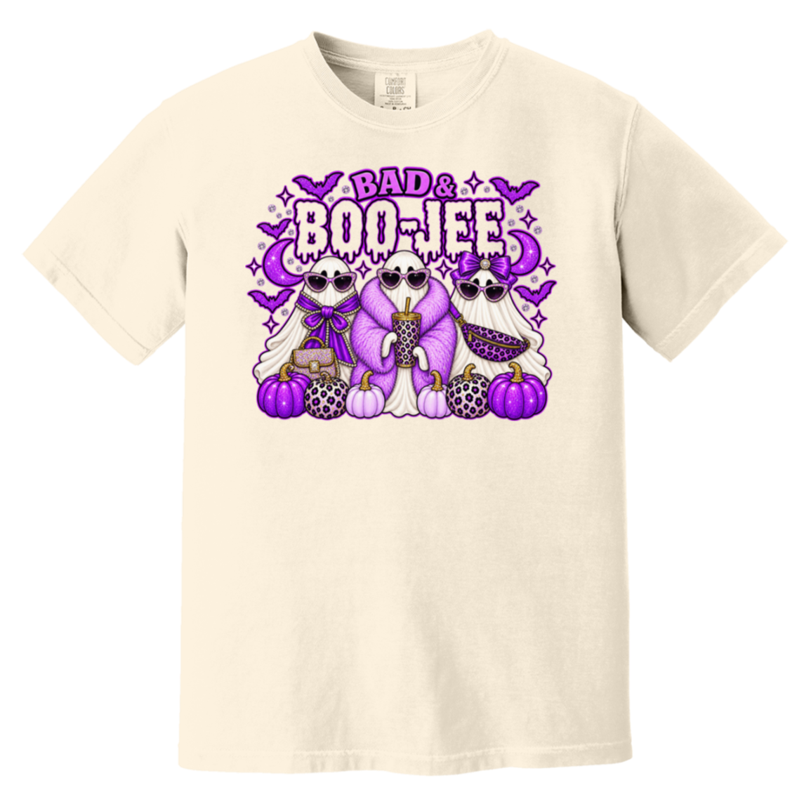 A cream-colored short-sleeve t-shirt with a colorful graphic on the chest featuring three cartoon ghosts, purple pumpkins, bats, and the text 'BAD & BOO-JEE'.