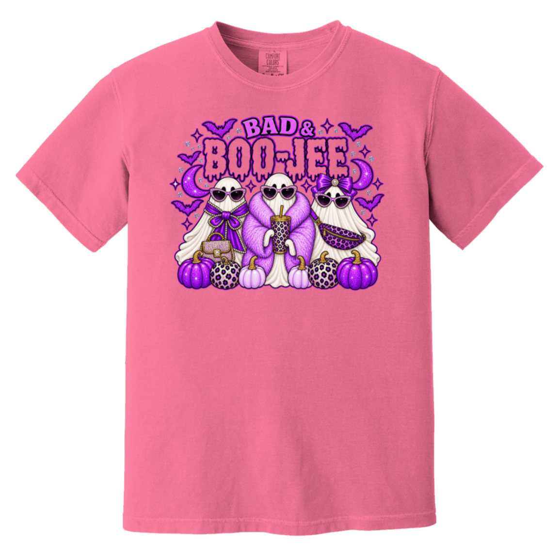 A pink short-sleeve crewneck t-shirt featuring a colorful graphic print of three cartoon ghosts wearing sunglasses and suits, standing with pumpkins under the text 'BAD & BOO-JEE' in purple and pink.