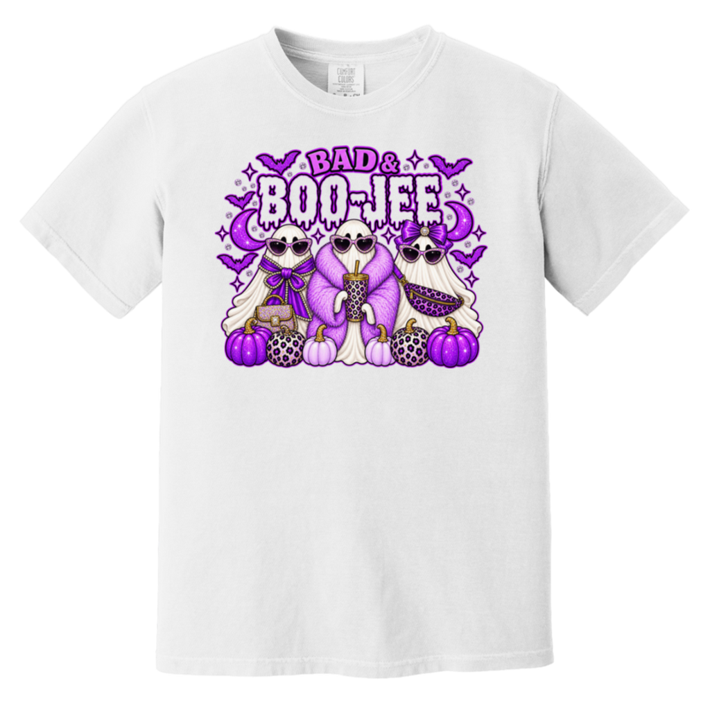 A white short-sleeve crewneck t-shirt featuring a colorful graphic print on the front. The graphic shows three cartoon ghosts in purple and black patterned outfits with purple pumpkins, bats, and the text 'BAD & BOO-JEE’ in purple and black.