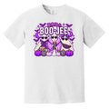 A white short-sleeve crewneck t-shirt featuring a colorful graphic print on the front. The graphic shows three cartoon ghosts in purple and black patterned outfits with purple pumpkins, bats, and the text 'BAD & BOO-JEE’ in purple and black.