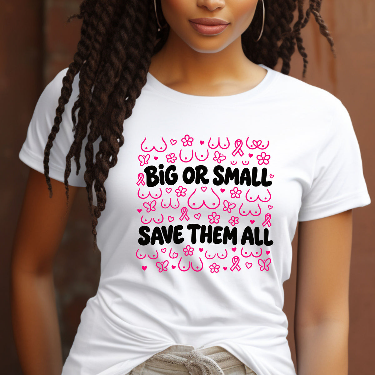 A woman wearing a white short-sleeve T-shirt with a pink and black awareness-themed graphic that reads 'BIG OR SMALL SAVE THEM ALL' surrounded by breast cancer awareness symbols.