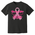 A black short-sleeve t-shirt with a pink graphic on the front. The graphic features a pink ribbon and the text 'Yes they're fake' and 'The real ones tried to kill me!' in pink lettering.