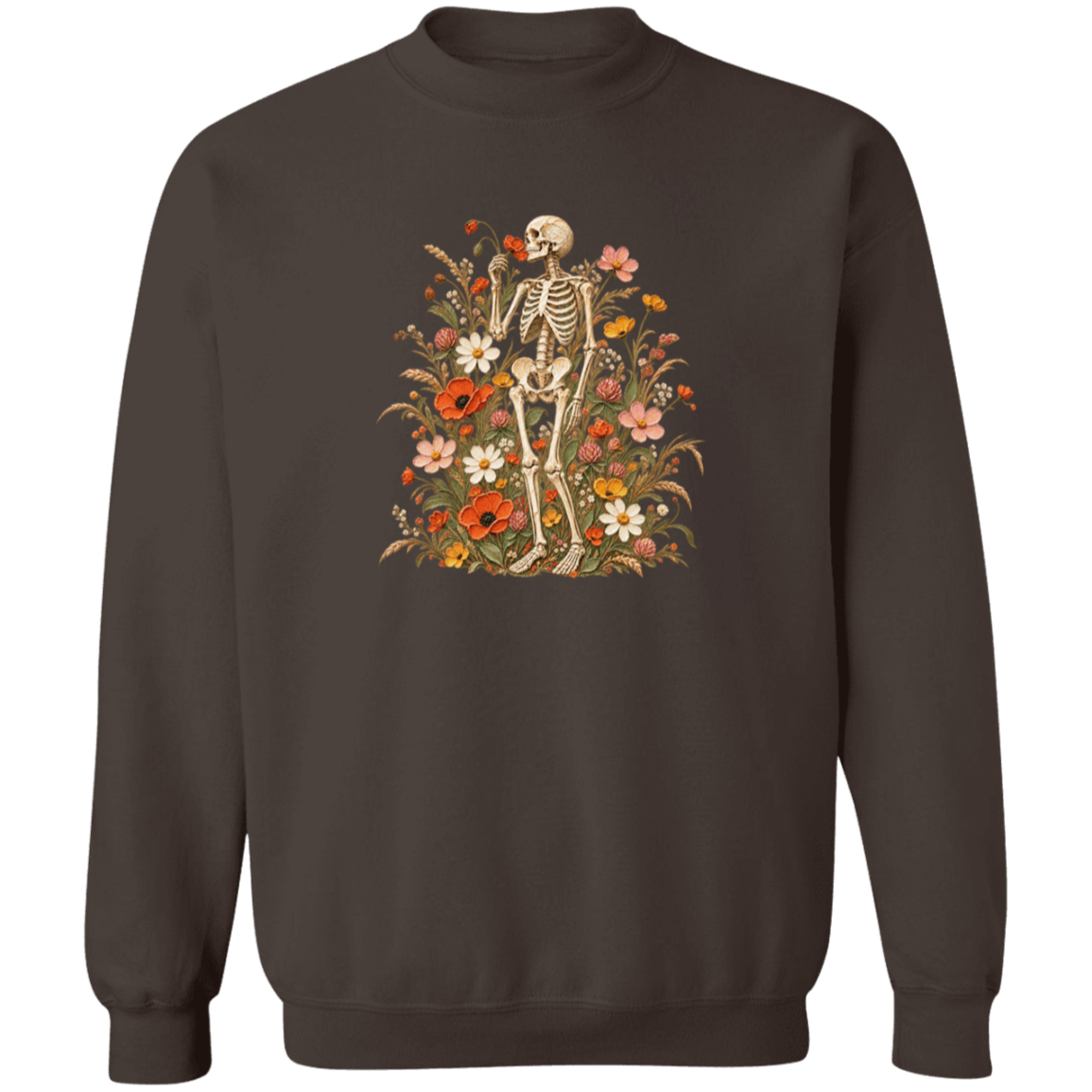 A dark brown crewneck sweatshirt featuring a central graphic of a skeleton surrounded by a dense arrangement of colorful wildflowers, including red, orange, pink, and white blossoms.