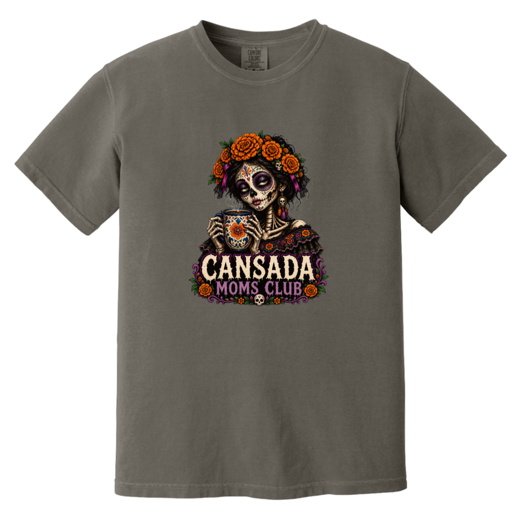 A dark gray crewneck t-shirt featuring a colorful Day of the Dead sugar skull graphic holding a teacup, with 'CANSADA MOMS, CLUB' printed below.