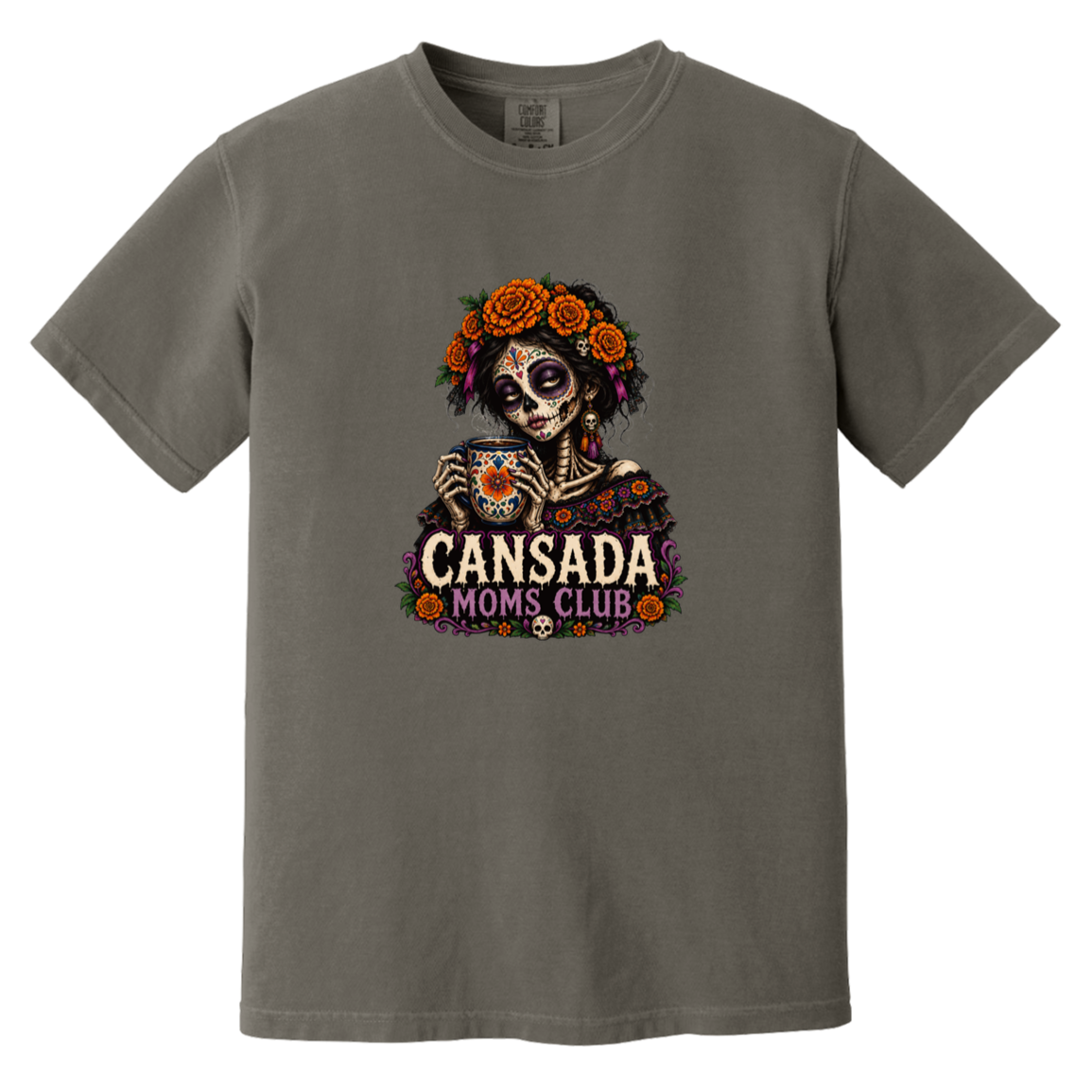 A dark gray crewneck t-shirt featuring a colorful Day of the Dead sugar skull graphic holding a teacup, with 'CANSADA MOMS, CLUB' printed below.