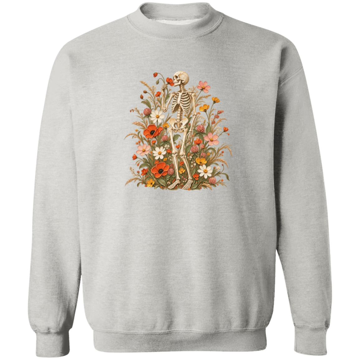 A light gray crewneck sweatshirt featuring a vintage-style graphic of a skeleton surrounded by a dense arrangement of red, orange, yellow, and white wildflowers.