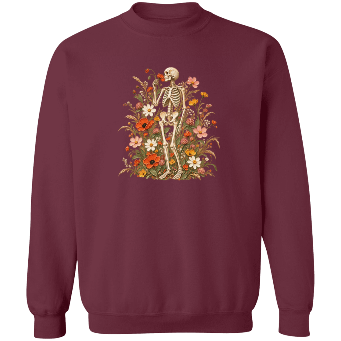 A crewneck sweatshirt in maroon with a central graphic of a skeleton standing amidst a dense arrangement of orange, pink, white, and yellow flowers.