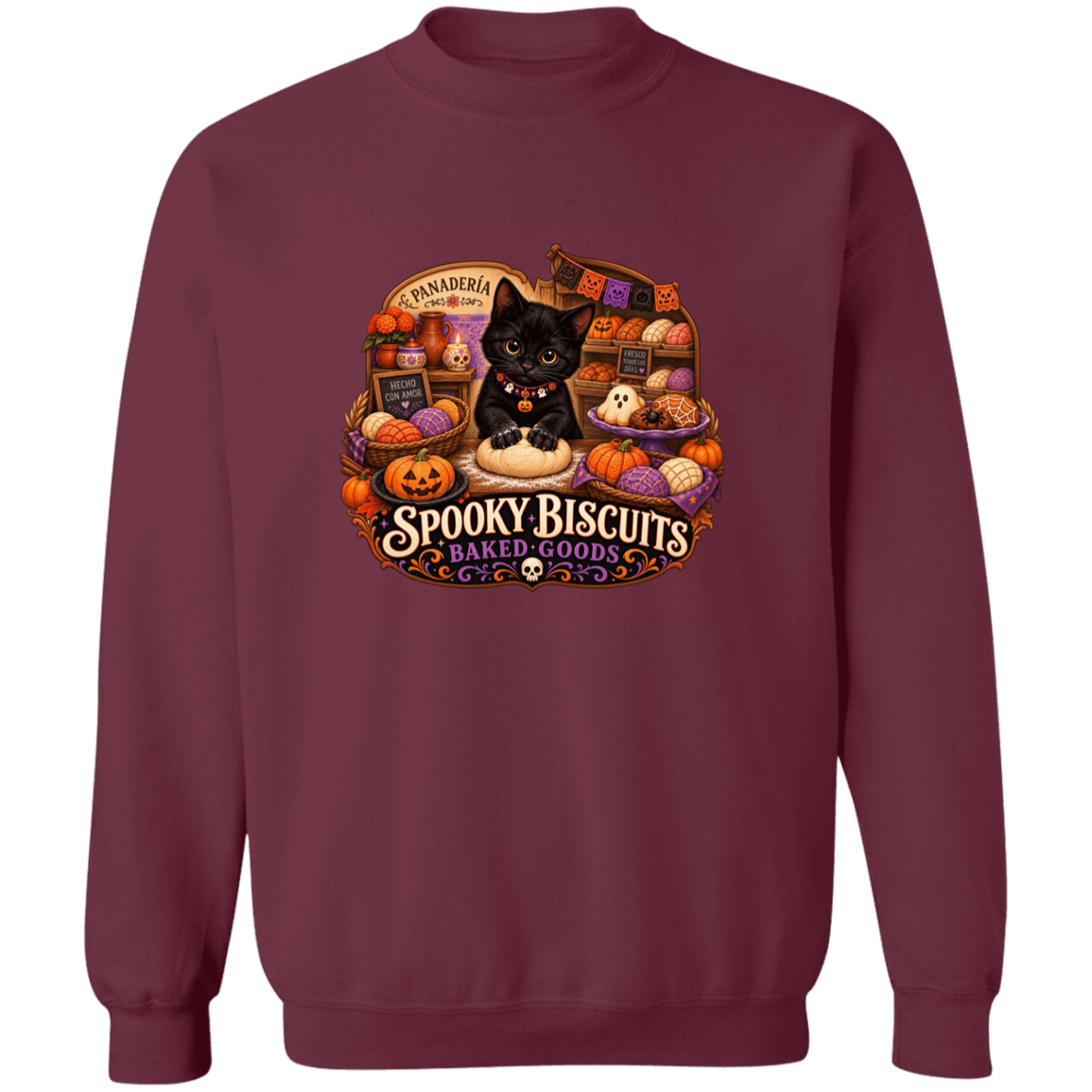 Maroon crewneck sweatshirt with a large, colorful Halloween-themed graphic on the front. The graphic features a black cat surrounded by pumpkins, ghosts, and the text 'Spooky Biscuits Baked Goods'.
