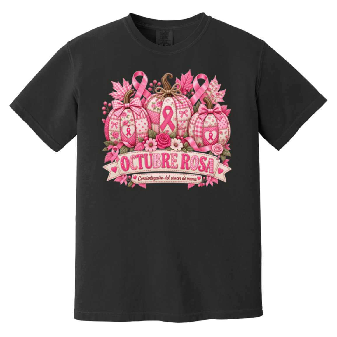Black short-sleeve graphic T-shirt laid flat on a rustic wood surface with autumn leaves and woven textiles around it. The shirt features a large pink breast-cancer awareness design with three patterned pumpkins, pink ribbons, flowers, and a banner reading 'OCTUBRE ROSA' with smaller Spanish text saying “concientizacion del cancer de mama”