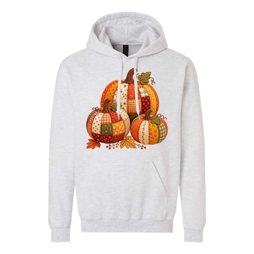 A light heather gray pullover hoodie featuring a colorful patchwork pumpkin graphic on the chest, displayed against a solid white background.