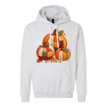 A light heather gray pullover hoodie featuring a colorful patchwork pumpkin graphic on the chest, displayed against a solid white background.