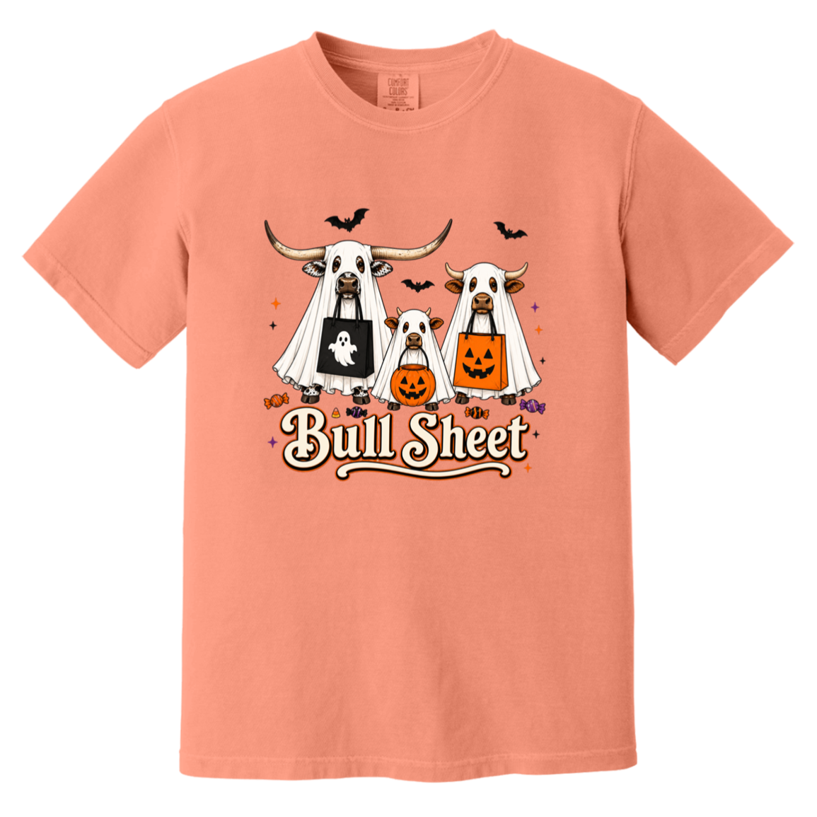 Peach crewneck t-shirt featuring a Halloween graphic of three longhorn bulls dressed in ghost costumes, with one pumpkin and one ghost bag, and the text 'Bull Sheet' written below.