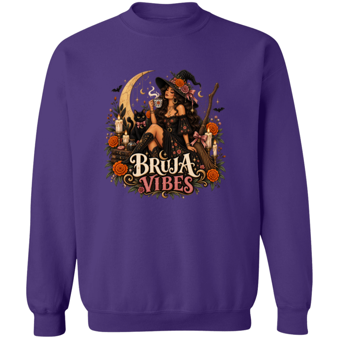 A purple crewneck sweatshirt with a large graphic print on the front. The graphic features a witch in a black hat sitting on a broomstick next to a black cat, surrounded by orange flowers and the text 'BRUJA VIBES'.