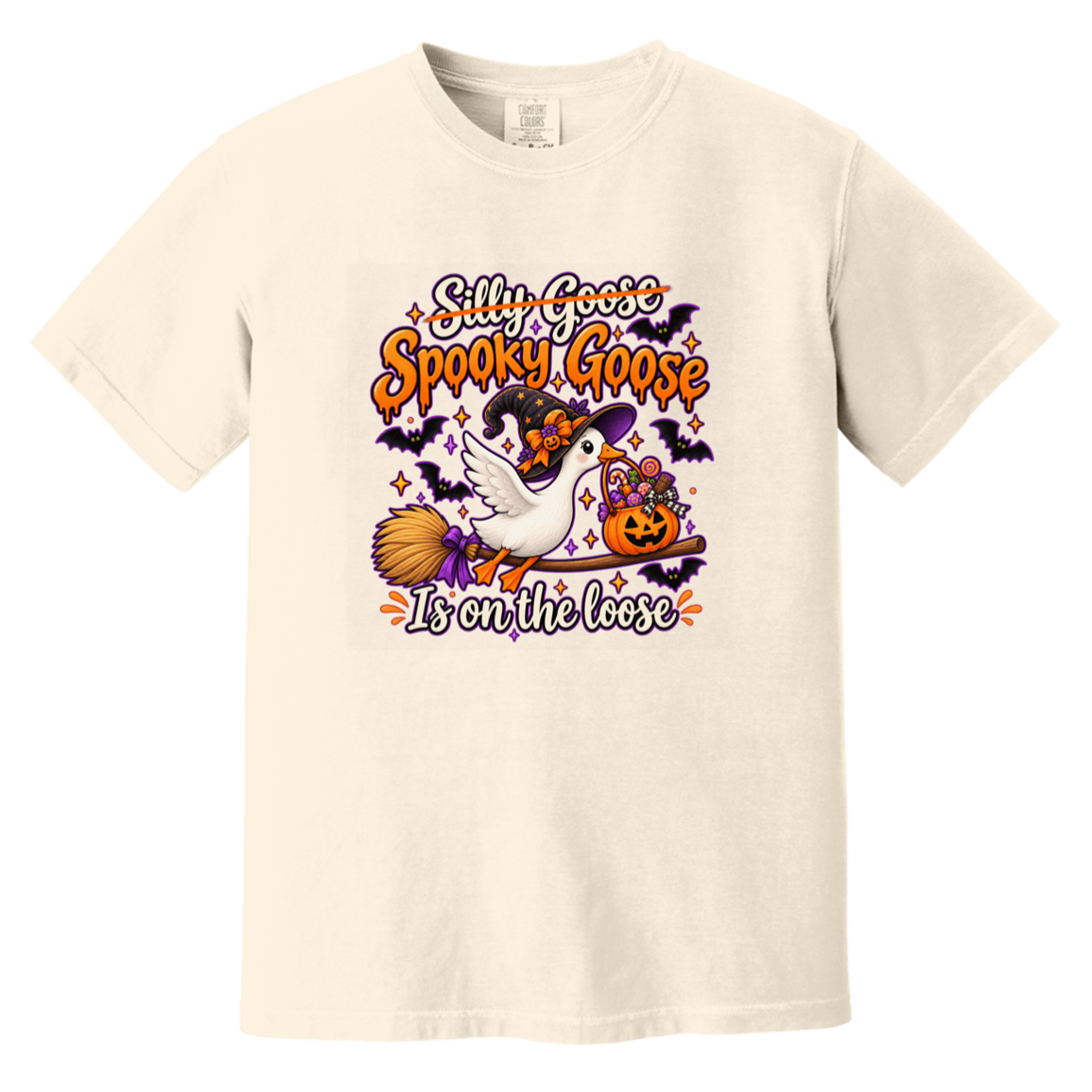 An off-white short-sleeve crewneck t-shirt featuring a colorful Halloween graphic on the front with the text 'Silly Goose Spooky Goose It's on the loose' and an illustration of a white goose, a witch, a broomstick, a jack-o'-lantern, and bats.