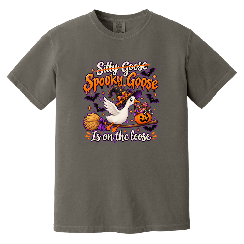 A dark gray crewneck t-shirt featuring a colorful Halloween graphic with a white goose, a witch's broom, a jack-o'-lantern, and bats, with the text 'Silly Goose Spooky Goose Is on the loose'.