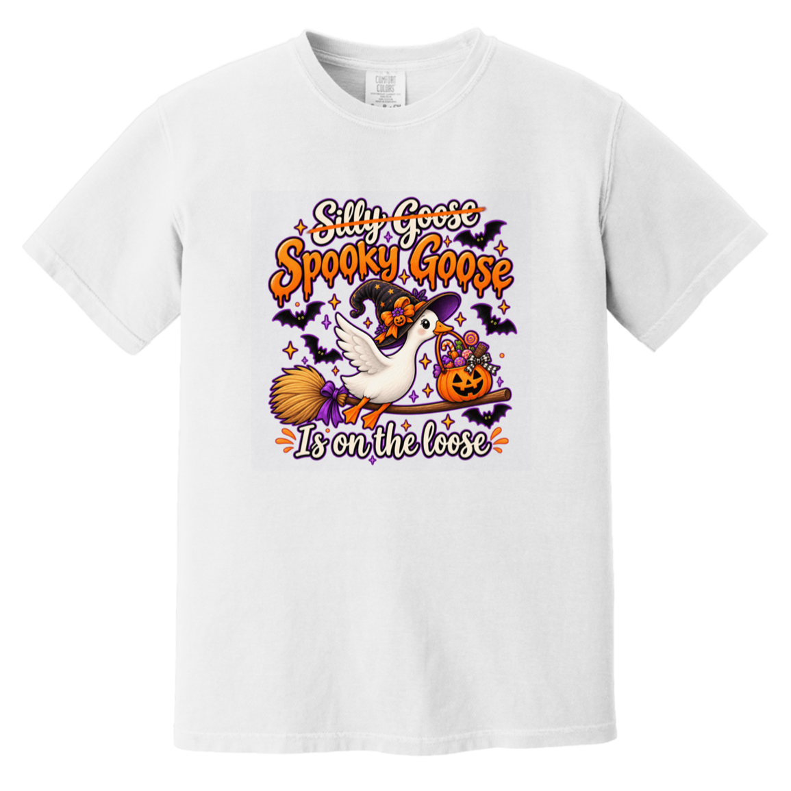 A white short-sleeve crewneck t-shirt featuring a colorful Halloween graphic on the chest. The graphic shows a white goose wearing a witch hat and broom, a jack-o'-lantern, bats, and the text 'Silly Goose Spooky Goose Is on the loose' in orange and white lettering.