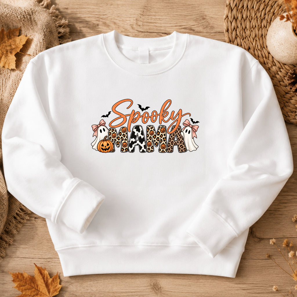 white crewneck sweatshirt with a 'Spooky Mama' graphic featuring Halloween-themed characters and patterns.
