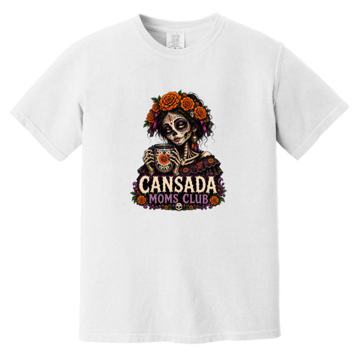 A white short-sleeve crewneck t-shirt featuring a colorful graphic of a Day of the Dead skeleton holding a teacup, with 'CANSADA MOMS, CLUB' printed below it.