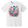 A white short-sleeve crewneck t-shirt featuring a colorful graphic on the front. The graphic displays a pink and teal awareness ribbon surrounded by pink flowers, green leaves, purple blossoms, and butterflies, with the text 'I am a previvor' written across the center.