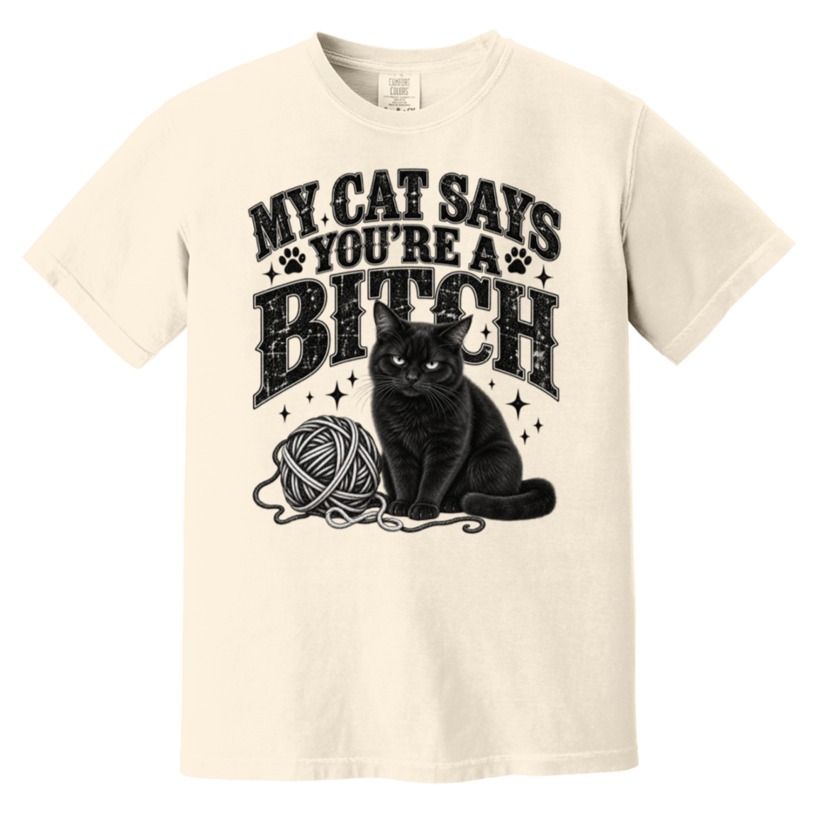 An off-white short-sleeve t-shirt with a black graphic print featuring the text 'MY CAT SAYS YOU'RE A BITCH' above an illustration of a black cat next to a ball of yarn.