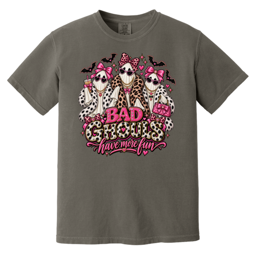 dark gray t-shirt with a graphic print of three ghosts dressed in faux fur outfits and pink bows, with the text 'BAD GHOULS have more fun' in pink and leopard print.