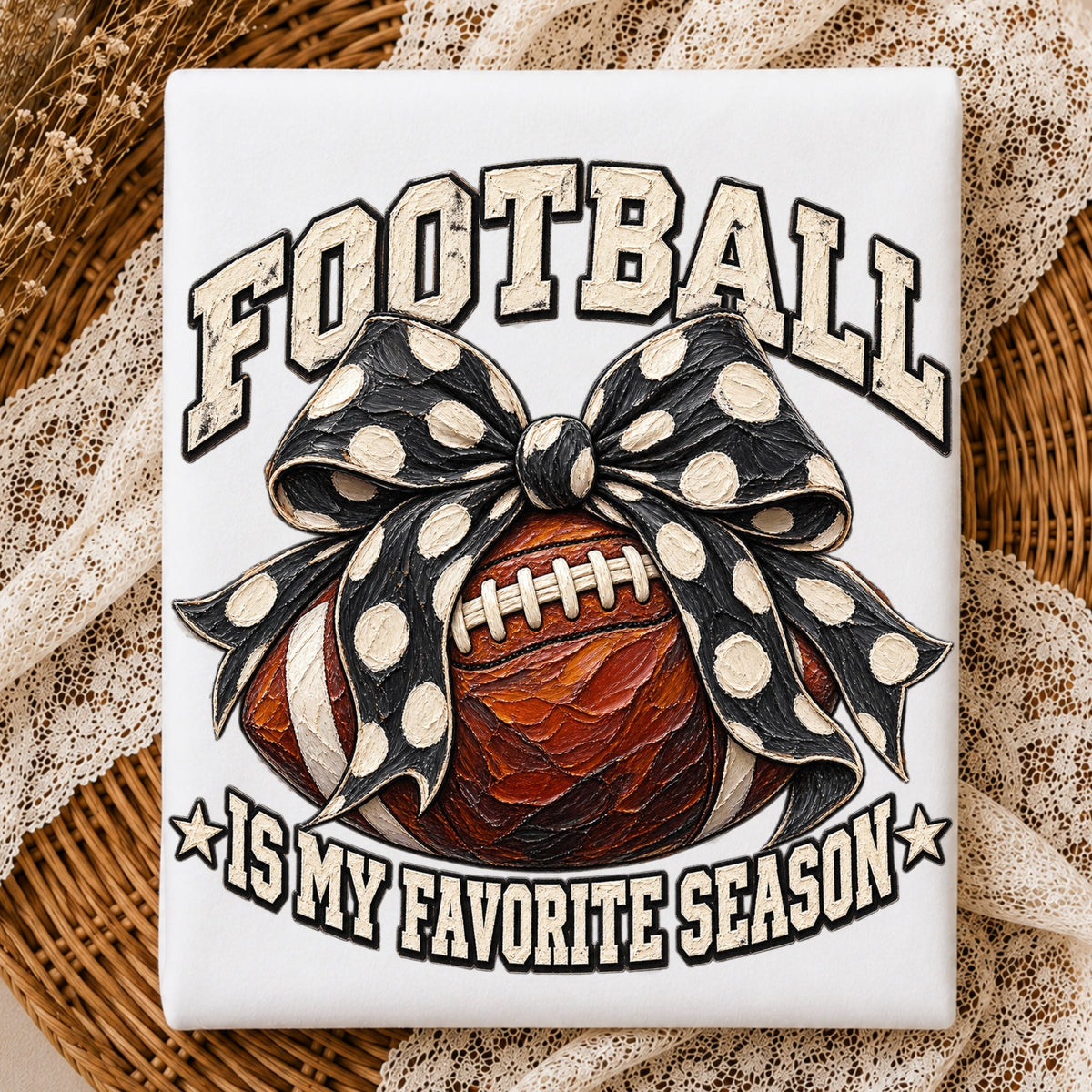 A square white shirt featuring a football design with a large black and white polka dot bow, surrounded by the text 'FOOTBALL IS MY FAVORITE SEASON'. The canvas is styled on a wicker tray with beige lace fabric.