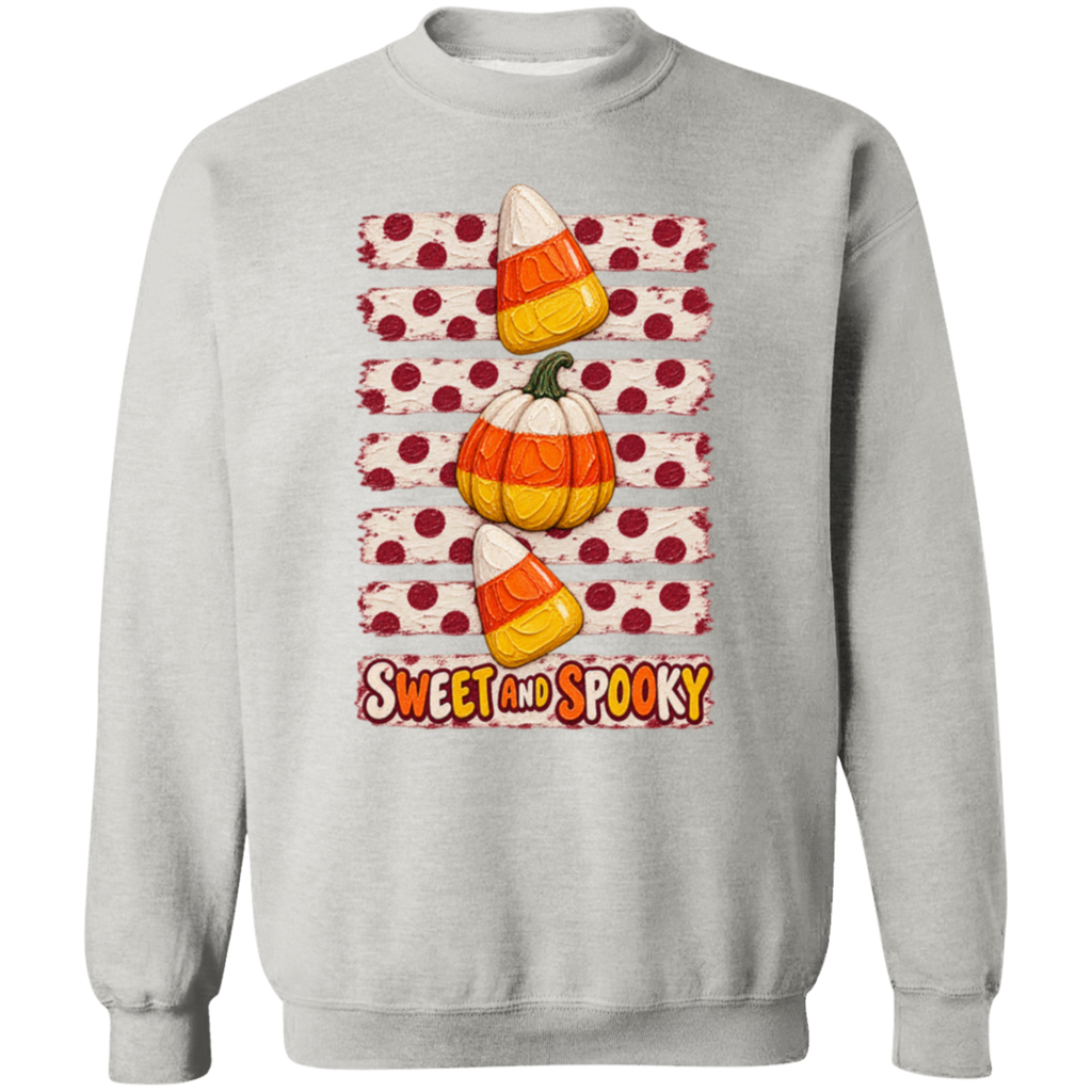 a gray sweatshirt with Halloween design with two candy corns, one pumpkin, red polka dots on a distressed cream background, and the words 'SWEET AND SPOOKY' at the bottom.