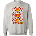 a gray sweatshirt with Halloween design with two candy corns, one pumpkin, red polka dots on a distressed cream background, and the words 'SWEET AND SPOOKY' at the bottom.