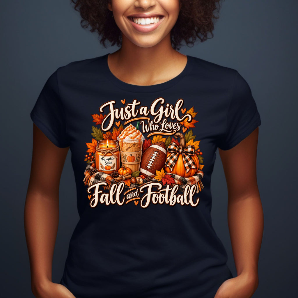 A woman wearing a navy blue graphic t-shirt with a fall-themed design that reads 'Just a Girl Who Loves Fall and Football' around illustrations of a fall candle, iced coffee, football, pumpkin, and plaid accents.