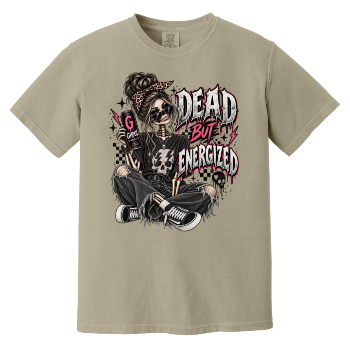 A beige crewneck t-shirt featuring a gothic-style graphic of a skeleton woman with sunglasses, a bandana, and ripped jeans, sitting cross-legged with the text 'DEAD BUT ENERGIZED' in a distressed font.
