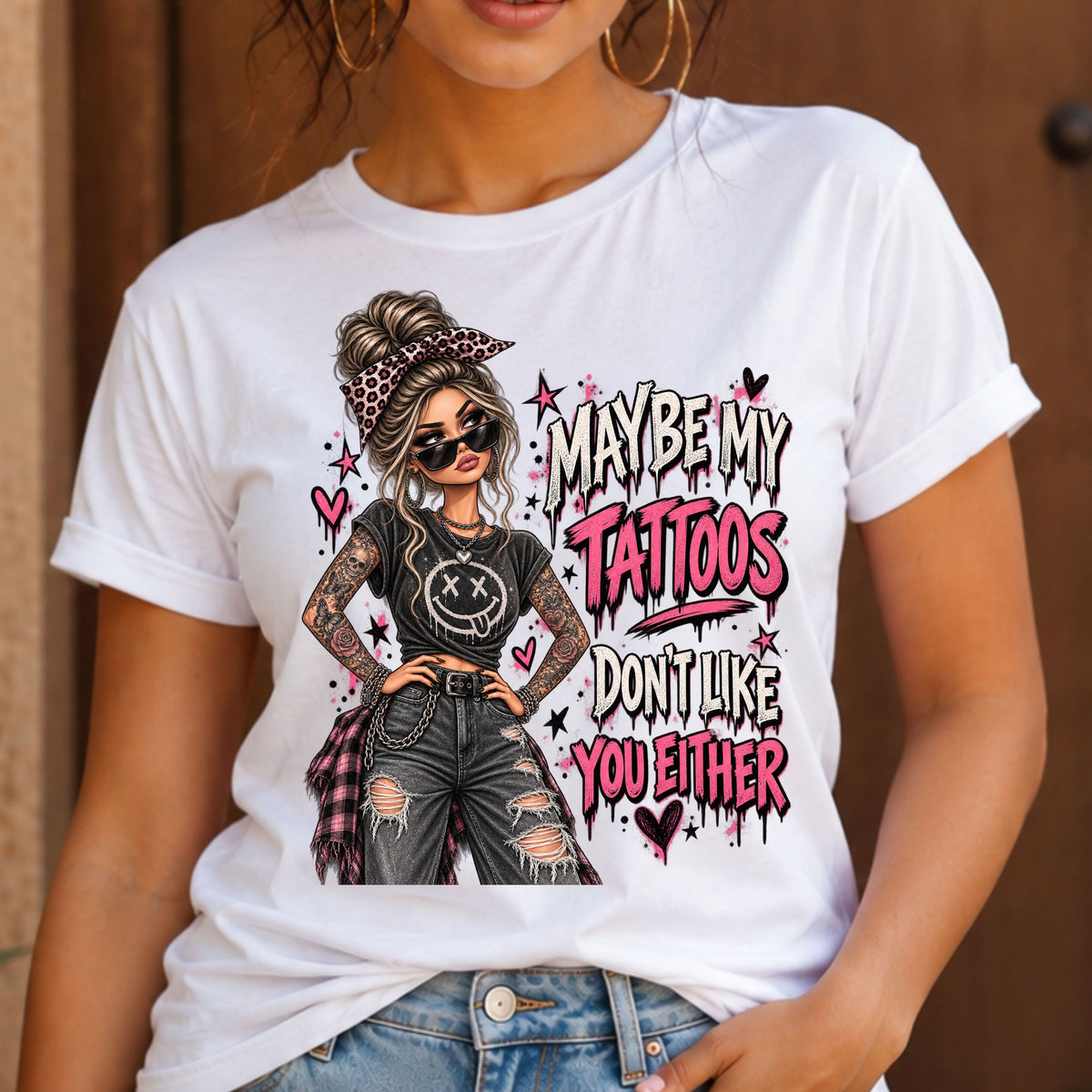 a woman wearing a white tshirt with a graphic of a woman with two sleeves of tattoos on her arms and a text that says "maybe my tattoos don't like you either" 