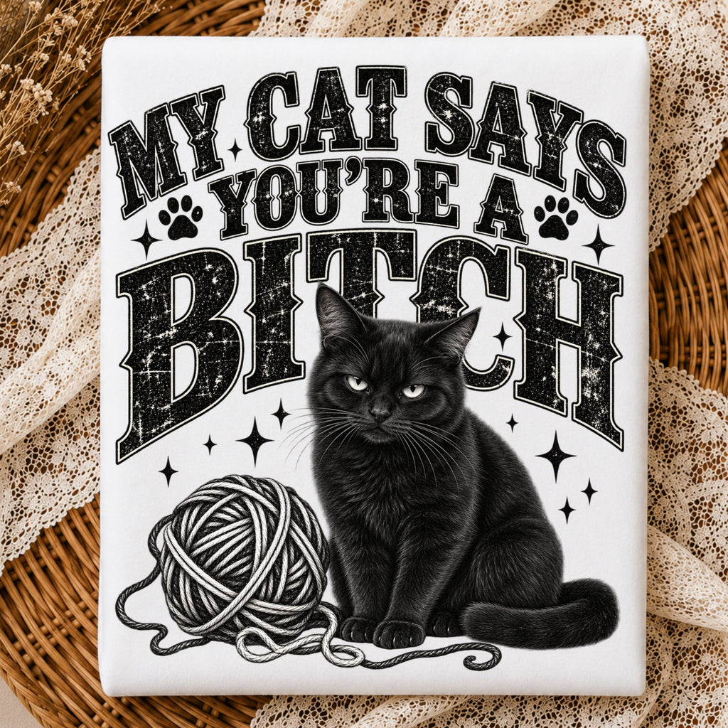 white folded tshirt with the text "my cat says you're a bitch" and a graphic of a black cat with a ball of yarn